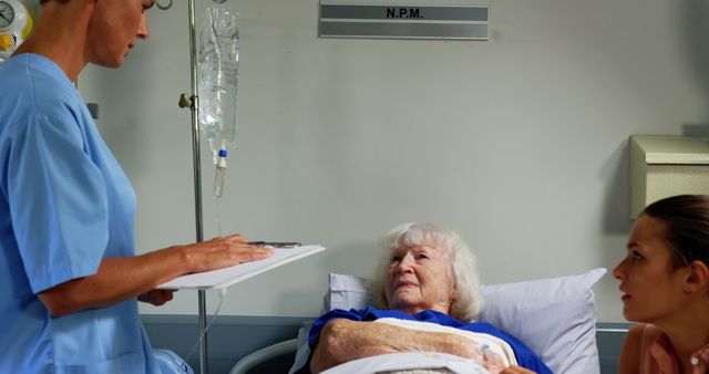 Nurse Monitoring Elderly Patient at Hospital Bedside with Concerned Family Member - Download Free Stock Images Pikwizard.com