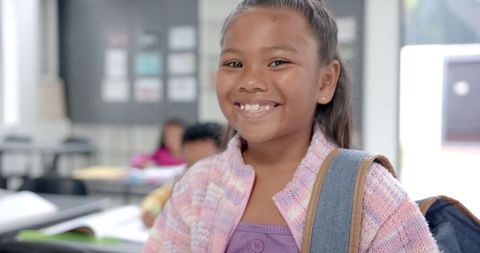 Smiling Schoolgirl with Backpack in Classroom, Ready for New Day - Download Free Stock Images Pikwizard.com