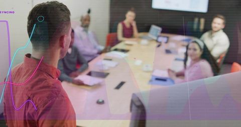 Business leader presenting analytics to team in boardroom with colorful digital overlay