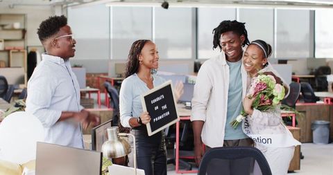 Coworkers Celebrating Achievement in Modern Office Environment