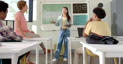 Teenage Student Presenting with Tablet in Modern Classroom