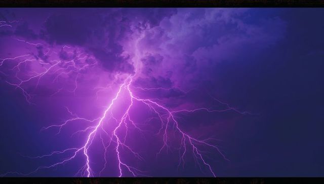 Dramatic Purple Lightning Splitting Sky in Night Thunderstorm