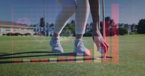 Golfer analyzing performance data on putting green