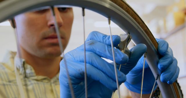 Mechanic Adjusting Bicycle Spokes Wearing Blue Gloves - Download Free Stock Images Pikwizard.com