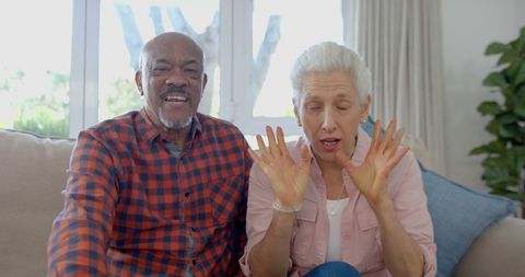 Joyful Senior Couple Having Video Call at Cozy Home