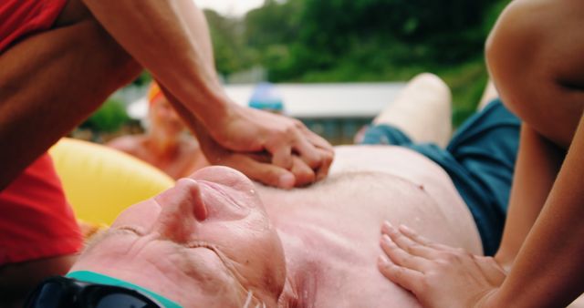 Lifeguard Performing CPR on Unconscious Man near Poolside - Download Free Stock Images Pikwizard.com