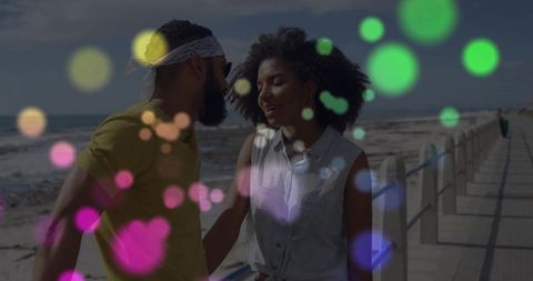 Couple sharing quiet conversation on seaside promenade with dreamy bokeh double-exposure