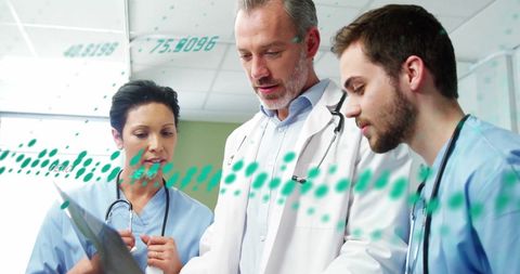 Medical team discussing data with digital interface