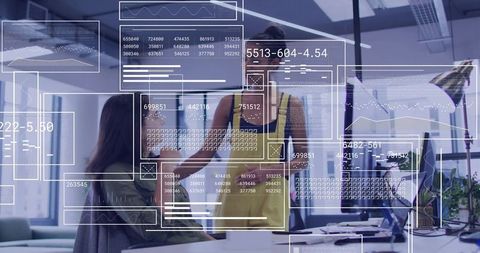 Woman presenting interactive data dashboards to colleague in open office with AR overlays
