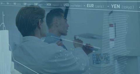 Business Professionals Analyzing Global Currency Exchange Rates in Modern Workspace