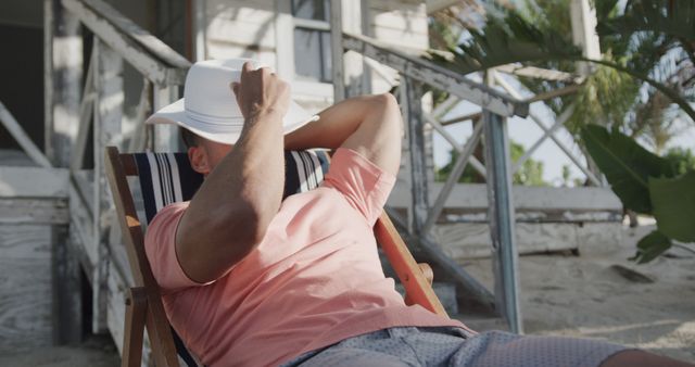 Man Relaxing in Deck Chair by Beach House on Sunny Day - Download Free Stock Images Pikwizard.com