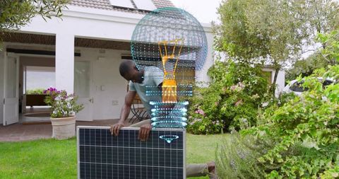 Man installing residential solar panel in garden with holographic energy visualization
