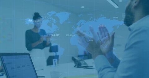 Business professionals clapping in conference room with world map overlay