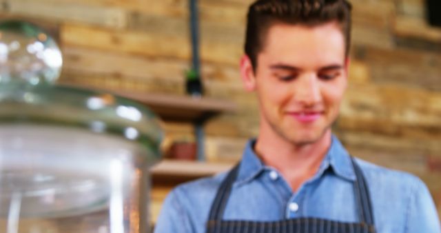 Man in Apron Smiling in Rustic Cafe Interior - Download Free Stock Images Pikwizard.com