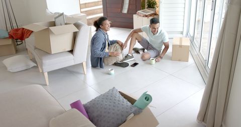 Happy Gay Couple Celebrating New Home During Move
