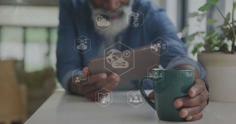 Man Holding Coffee Mug and Tablet in Modern Workspace