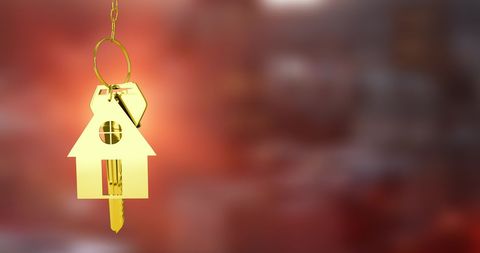 Golden house keys hanging symbolizing real estate investment