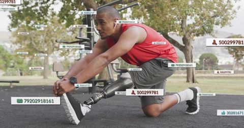 Stretching adaptive athlete with prosthetic leg during outdoor park workout