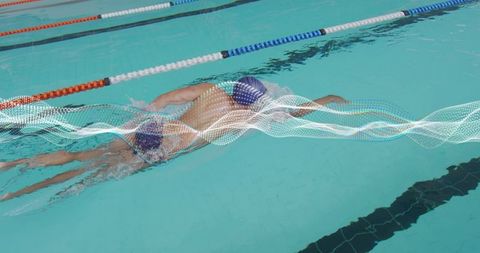 Competitive swimmer performing freestyle in turquoise lap pool with motion wave overlay