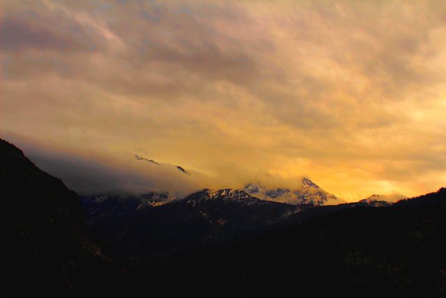 Majestic Mountains at Sunset under Dramatic Cloudy Sky - Download Free Stock Photos Pikwizard.com