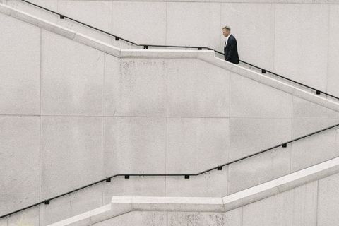 Businessman climbing concrete staircase plain photos in urban environment