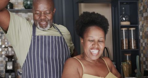 Joyful Senior African American Couple Cooking at Home