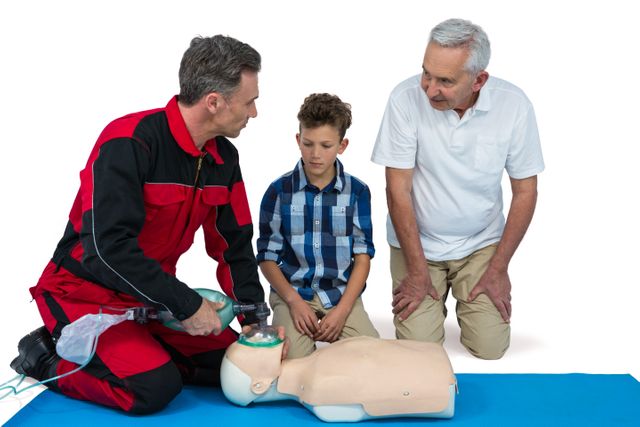 Paramedic demonstrating CPR techniques to a senior man and a child using a mannequin. Useful for educational materials, first aid training programs, healthcare awareness campaigns, and emergency response training resources.