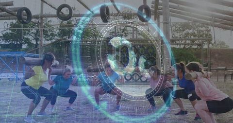 Women training with logs and squatting on outdoor obstacle course with holographic overlay