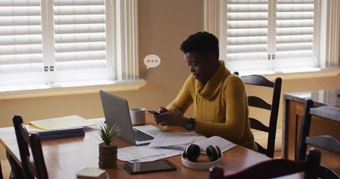 Remote Work Focus Woman Engaging with Smartphone at Dining Table
