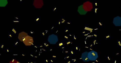 Gold confetti falling with colorful bokeh in dark background