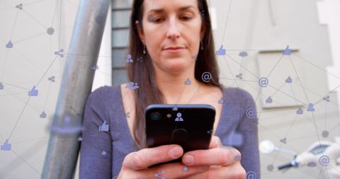 Woman using smartphone with network connections overlay