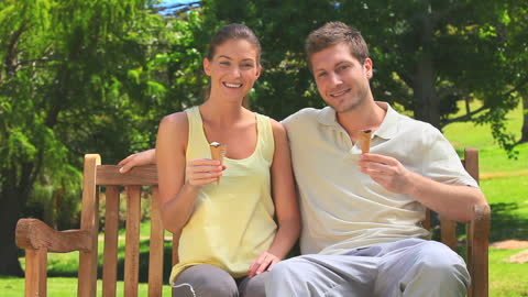 Couple Enjoying Ice Cream on Park Bench