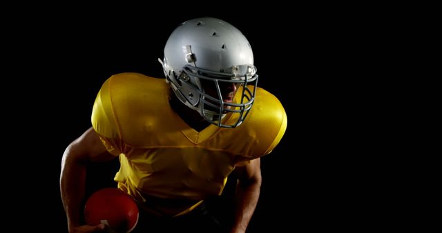 American Football Player Wearing Helmet and Yellow Jersey in Dark Background - Download Free Stock Images Pikwizard.com