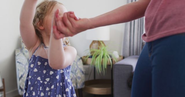 Mother and Daughter Holding Hands and Dancing in Living Room - Download Free Stock Images Pikwizard.com