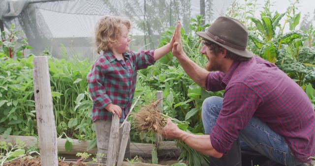 Father and son bonding while working in vegetable garden - Download Free Stock Images Pikwizard.com