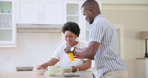 Parents Helping Child with School Routine in Kitchen