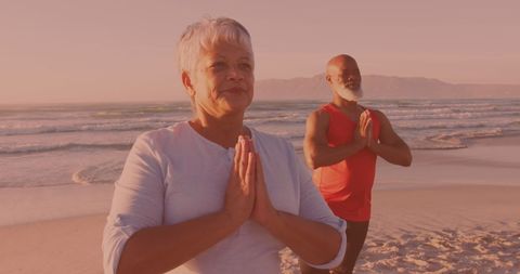Senior Couple Meditating on Serene Beach at Sunset - Download Free Stock Images Pikwizard.com