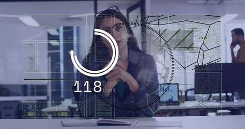 Female analyst studying hud analytics and map overlays on glass in open-plan office