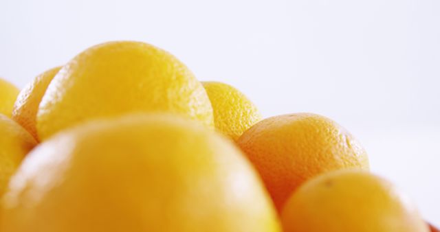 A close-up view of fresh, vibrant lemons and oranges against a light background, with copy space - Download Free Stock Photos Pikwizard.com