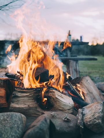 Warm Campfire Flames in Outdoor Settings at Dusk