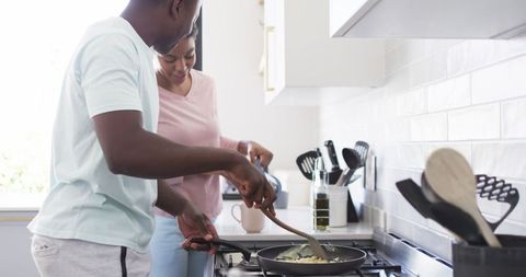 Young Couple Cooking Breakfast Together in Modern Kitchen