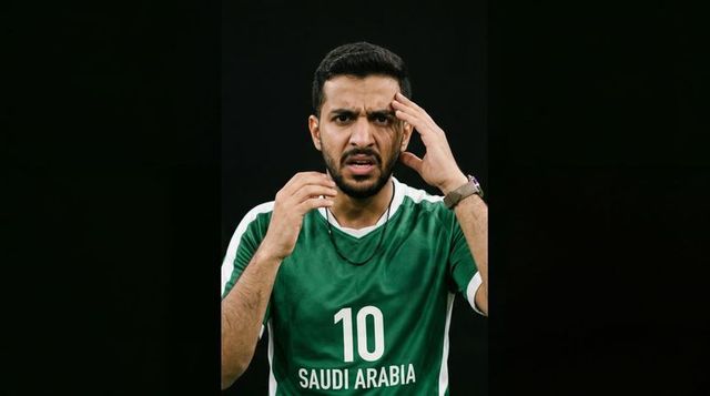 Tense saudi arabia soccer player touching temple adjusting cord wearing number 10 jersey