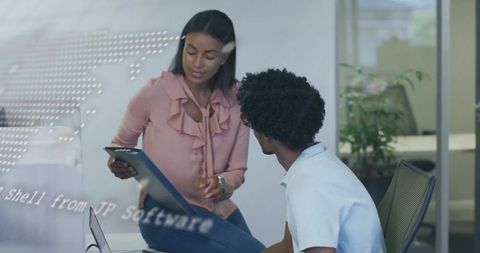 Business Colleagues Collaborating on Digital Tablet in Modern Office