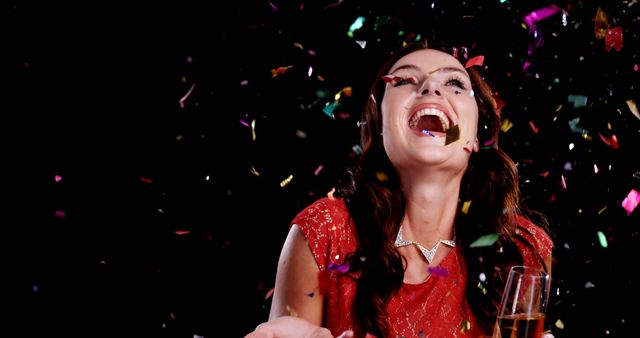 Joyful Celebration Woman with Falling Confetti and Champagne - Download Free Stock Images Pikwizard.com