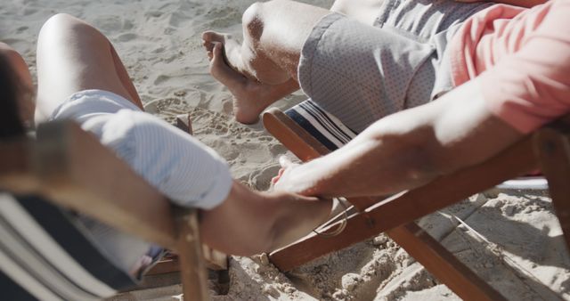 Couple Relaxing on Beach Loungers by the Sea - Download Free Stock Images Pikwizard.com