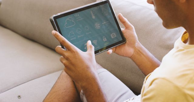 Man Using Smart Home Application on Tablet at Home - Download Free Stock Images Pikwizard.com