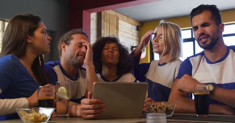 Disappointed sports fans reacting to game loss