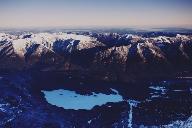Aerial View of Snow-Capped Mountain Range with Lakes and Forests at Sunset - Download Free Stock Photos Pikwizard.com