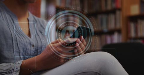 Biracial Woman Engaged with Smartphone in Library Environment