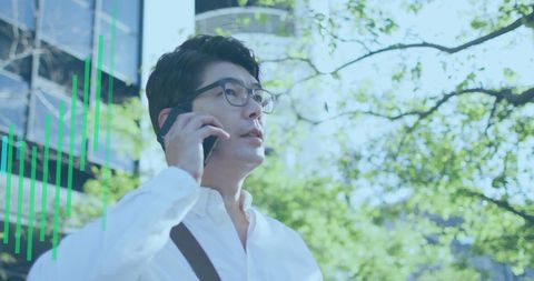 Asian Professional Engaging in Business Call with Growth Graph Overlay - Download Free Stock Images Pikwizard.com